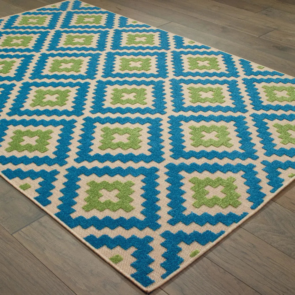 Colorful geometric area rug in blue, green, and cream, featuring a modern pattern perfect for any home decor.