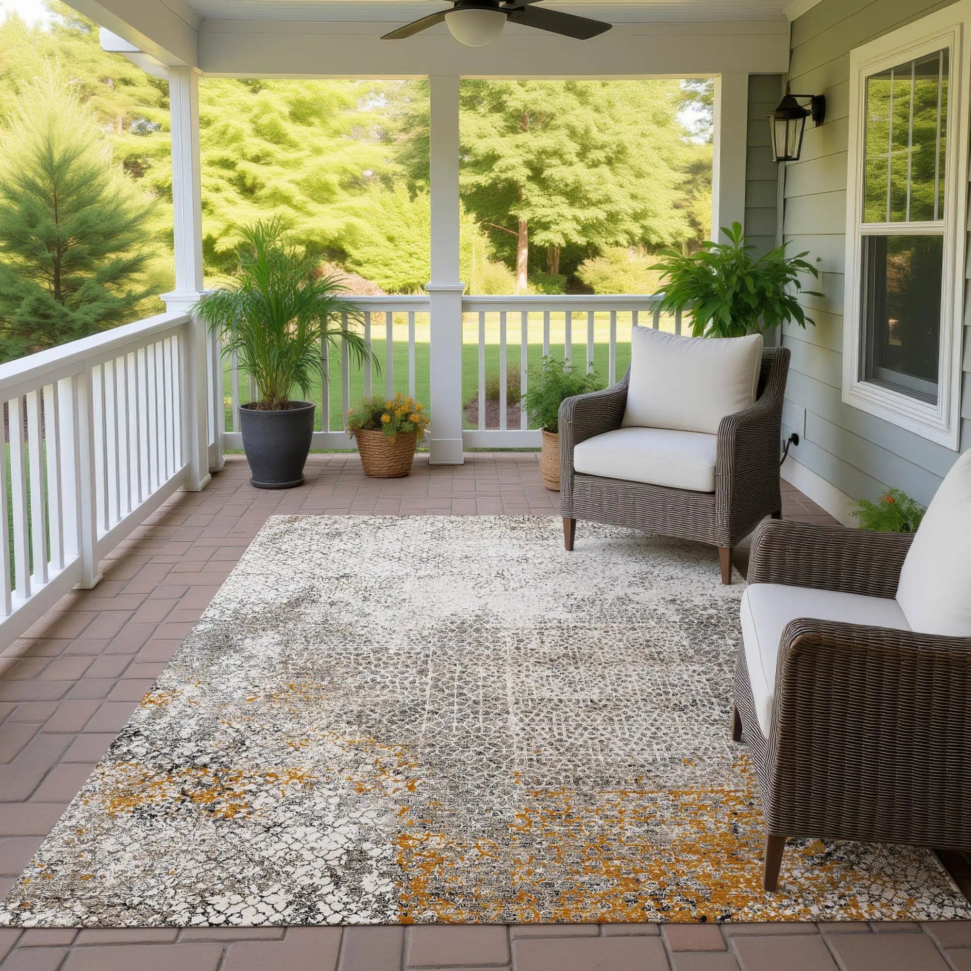 Textured indoor/outdoor area rug in gray, beige, and mustard yellow, perfect for porches and patios. Stylish and durable.