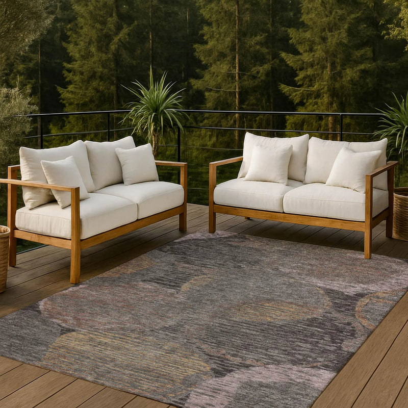 Beige outdoor sofa set with natural wood frame and plush cushions, paired with a colorful abstract patterned rug.