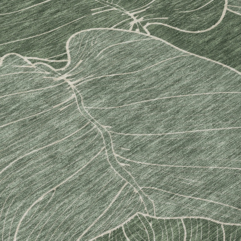 Green woven area rug with large white leaf patterns, perfect for a modern, nature-inspired decor.