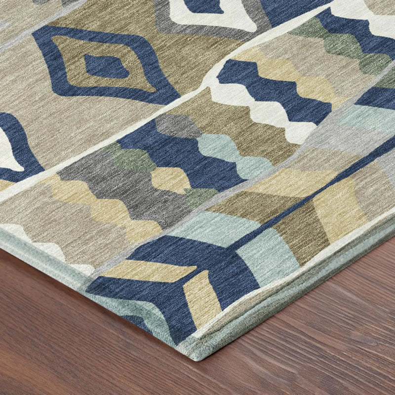 Multicolored area rug with blue, green, and beige geometric patterns on a hardwood floor.