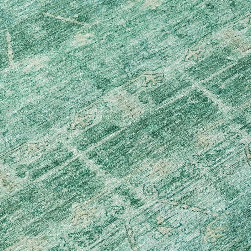 Turquoise vintage-inspired area rug with intricate patterns, soft wool blend material, perfect for stylish decor.