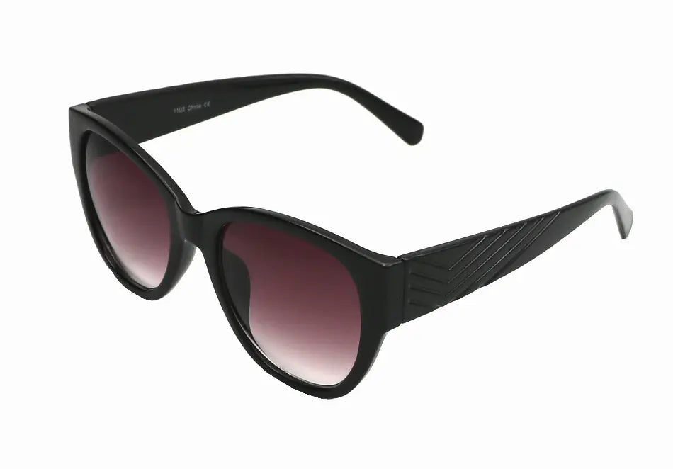 Black cat-eye sunglasses with gradient purple lenses and textured side detailing, perfect for a chic summer look.