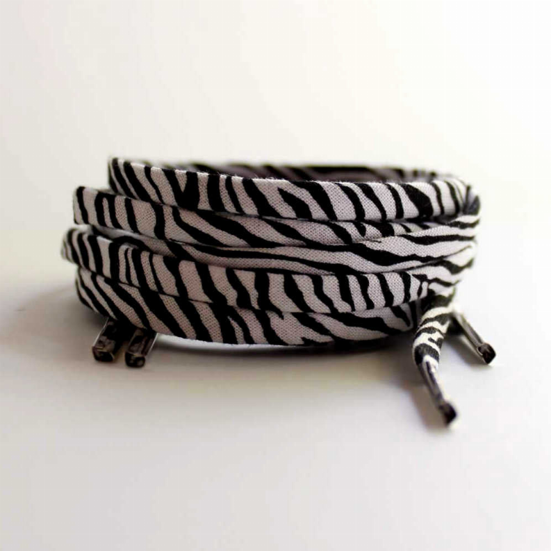 Zebra print shoelaces, black and white striped, rolled with metal aglets