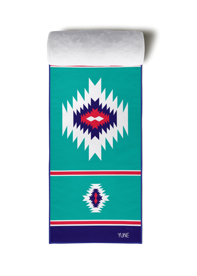 Teal yoga towel with native-style geometric print, dark blue border, and YUNE label