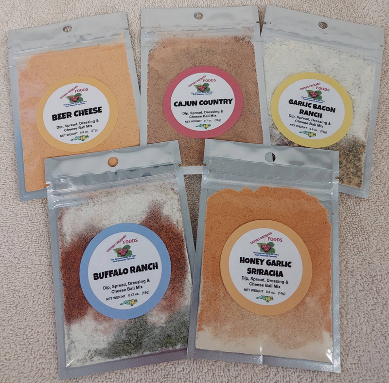 Assorted dip mix seasoning packets with labels: Beer Cheese, Cajun Country, Honey Garlic Sriracha