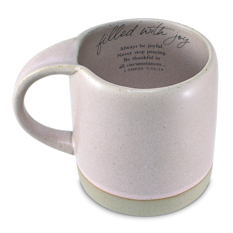 Speckled pink ceramic mug with “filled with joy” quote and verse on inner base