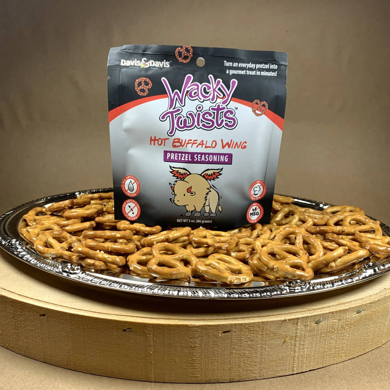 Hot Buffalo Wing pretzel seasoning pouch with pretzel twists on a platter