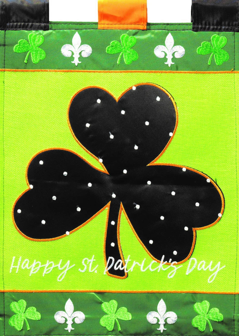 Close-up St. Patrick's Day flag: green shamrocks, black clover heart, 'Happy St. Patrick's Day'