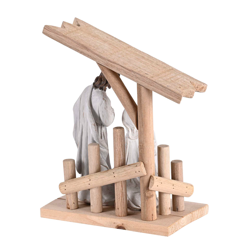 Nativity wooden creche with Holy Family figures behind tall wood beams and posts