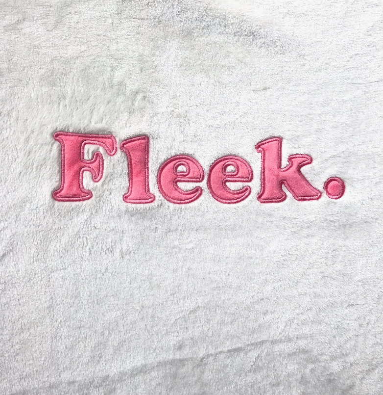 Plush fleece nap blanket in light gray with Fleek logo