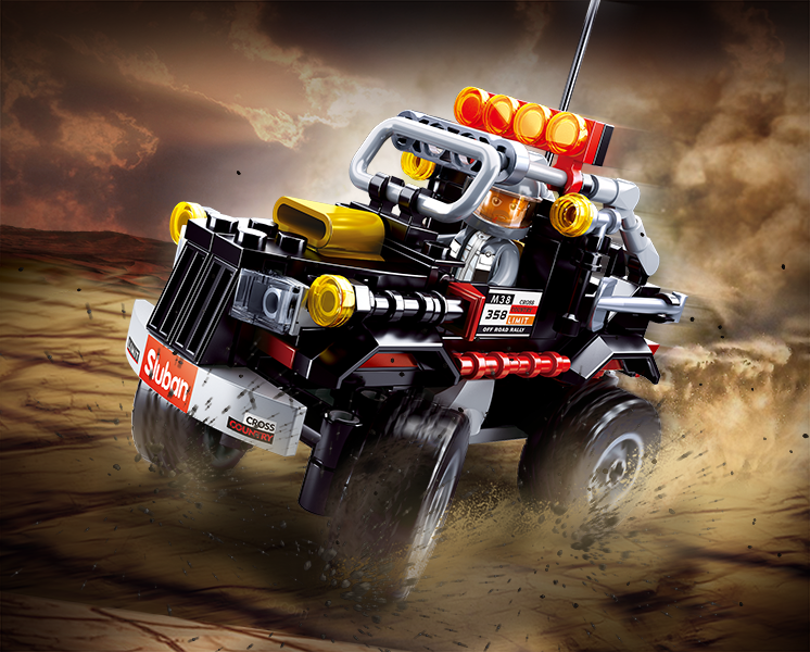 Off-road brick truck with orange light bar, gray engine, red frame, and big tires