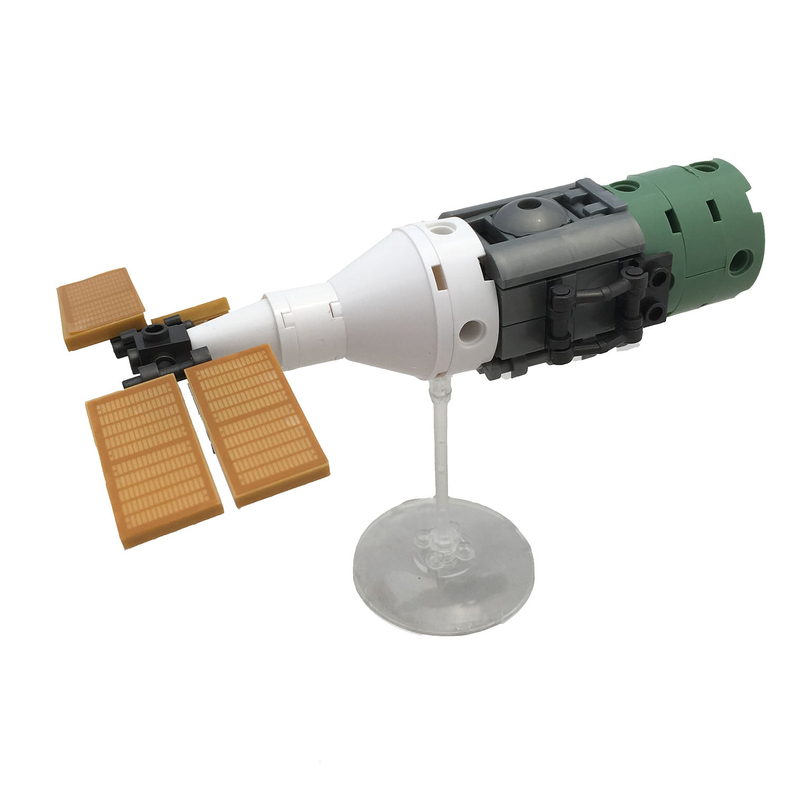 Space cargo ship brick model on stand with green nose, white body, and brown solar panels
