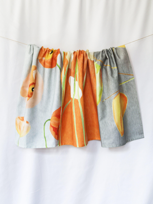 Orange and grey striped tea towel with scattered flowers