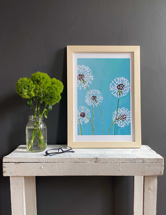 Framed art print: aqua background with white dandelions, dark centers, and green stems