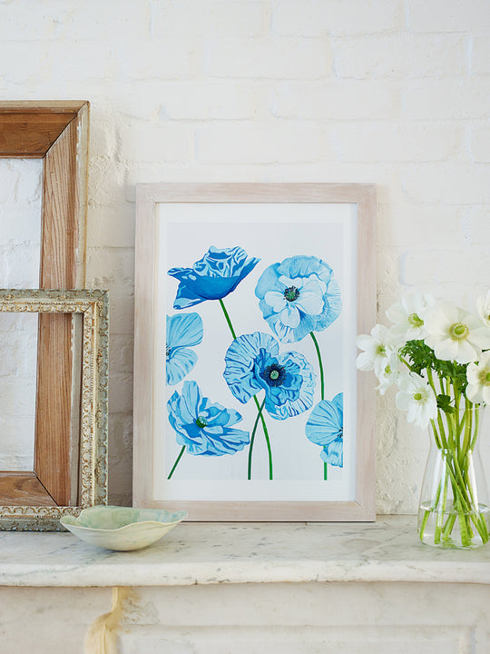 Framed art print with blue and light-blue flowers on a white background