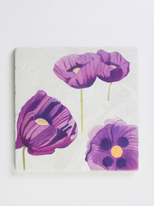 Square white trivet featuring purple flower cluster design with yellow centers