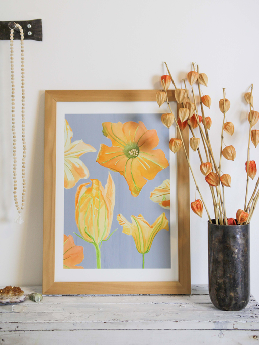Framed orange flower art print with tulip-like blossoms in wooden frame