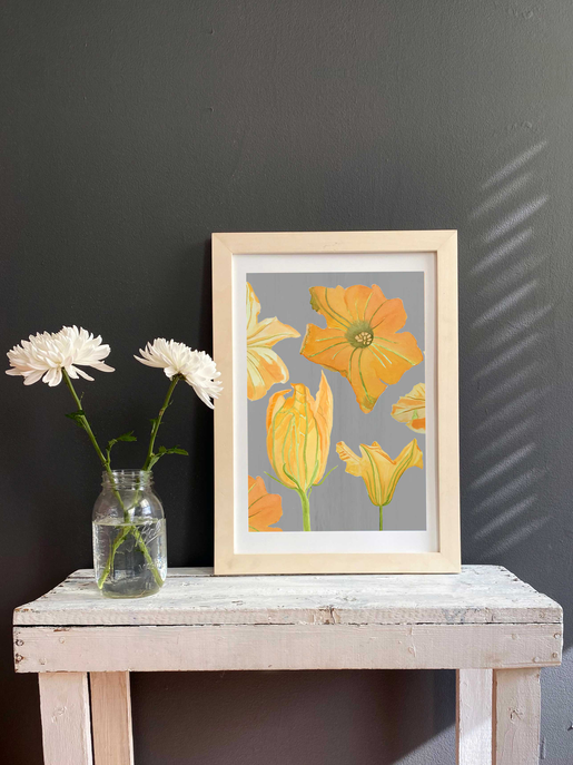 Framed orange and cream tulip-like flower art print in white mat