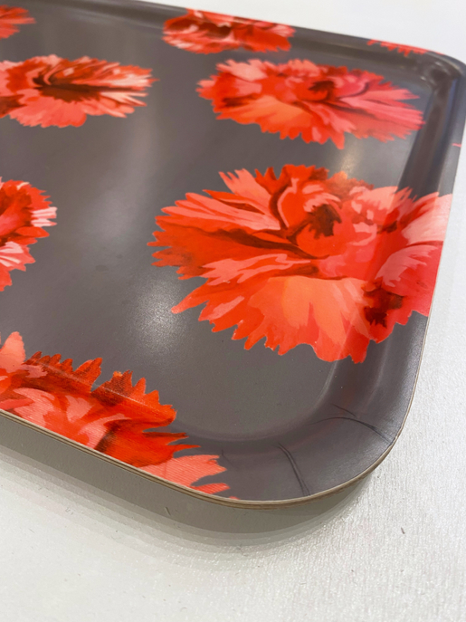 Rectangular serving tray corner detail with bright red orange flower print