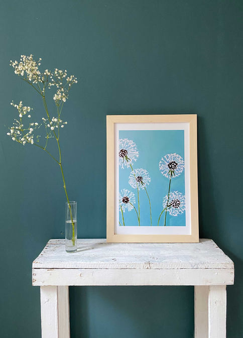 Framed aqua art print with white dandelions on blue background