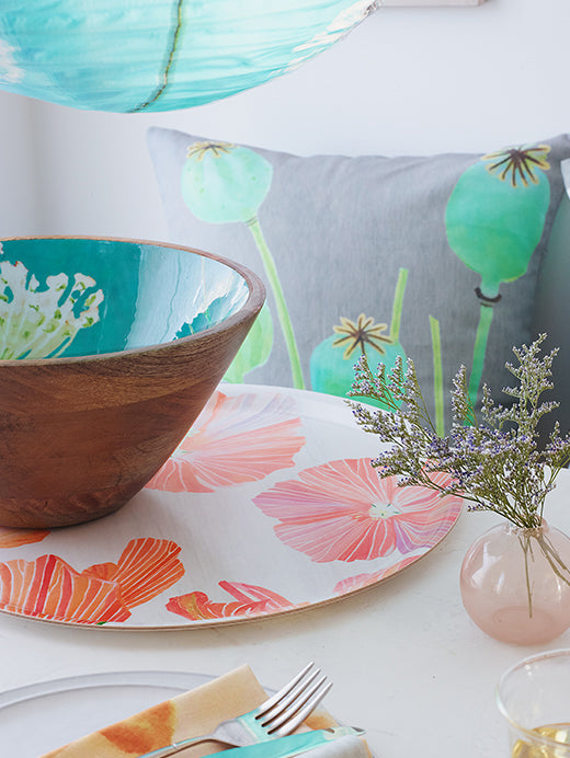 Round serving tray with orange and pink hibiscus floral print, partial view