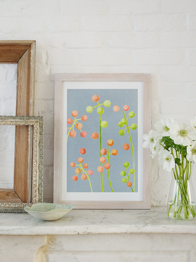 Framed floral art print featuring orange and green dot clusters on a gray-blue field