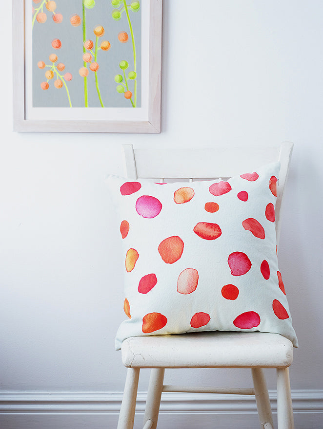 Light gray framed floral art print, partial view of orange and green dot clusters