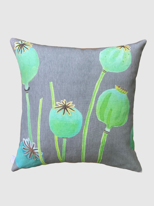 Rectangular throw pillow with green seed-pod print on gray fabric