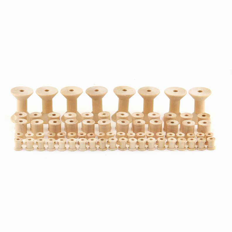 Multiple light wood thread spools with central holes in rows