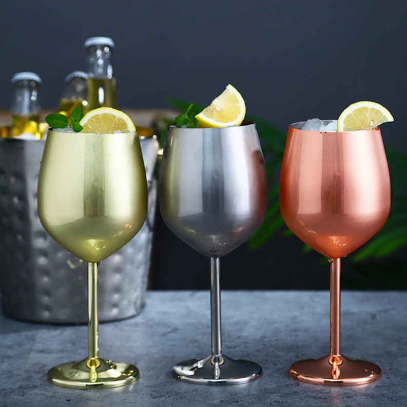 Stemmed cocktail glasses set with gold, silver, and rose metallic finish, lemon wedges
