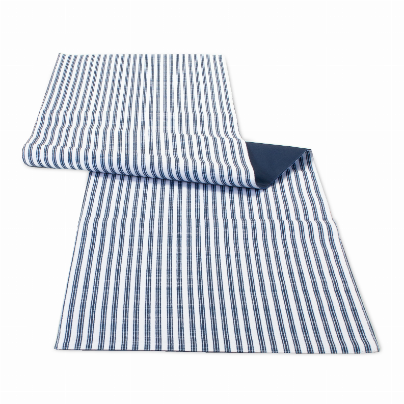 Polyester table runner with blue-and-white vertical stripes, folded corner showing dark backing