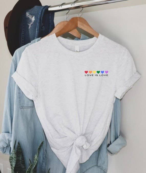White crewneck T-shirt with knotted front and “LOVE IS LOVE” rainbow heart chest print