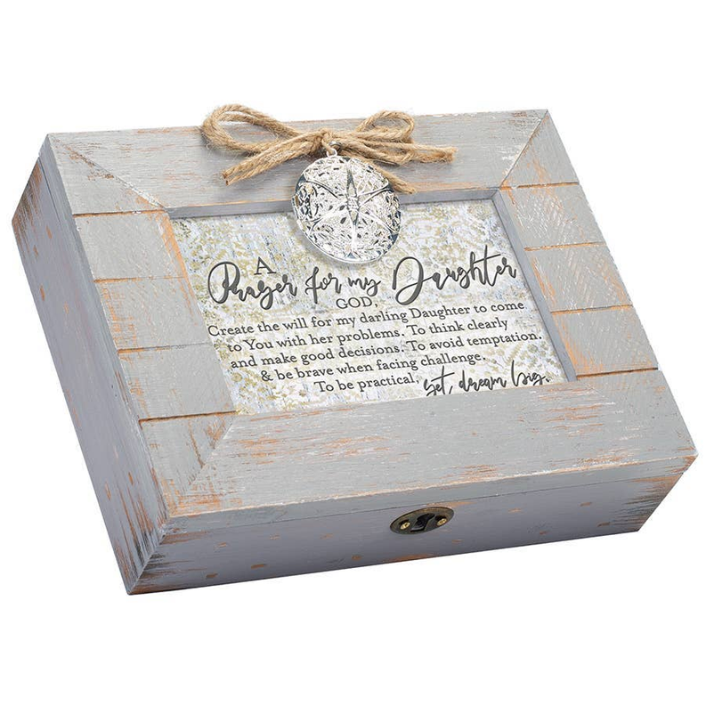 Gray distressed wooden music box lid with silver medallion seal and engraving
