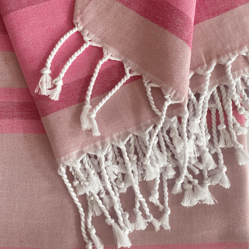 Pink Turkish towel with square stripes and dense white braided fringe edging