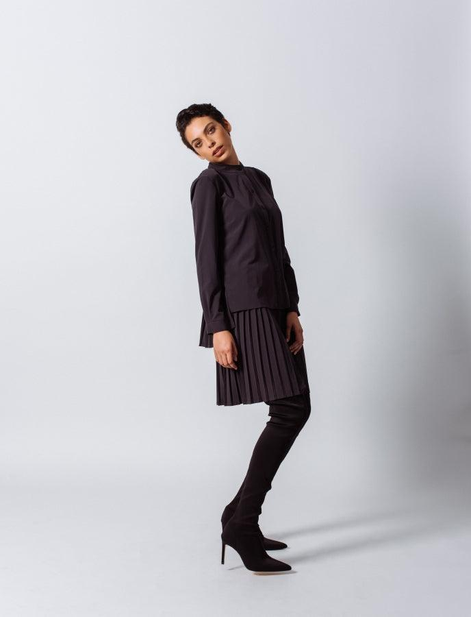 Black pleated midi skirt with accordion pleats and elastic waistband, front 3/4 view