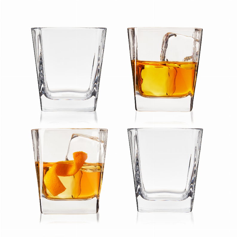 Set of four square rocks cocktail glasses, some filled with amber drinks and ice