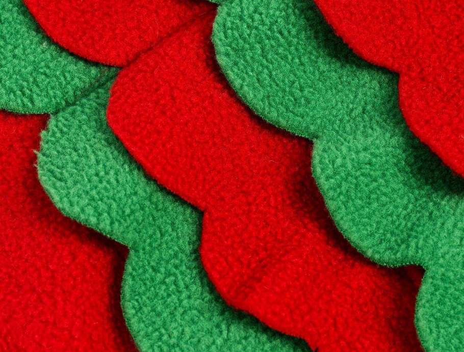 Close-up of felt snuffle mat with green and red layered fabric strips