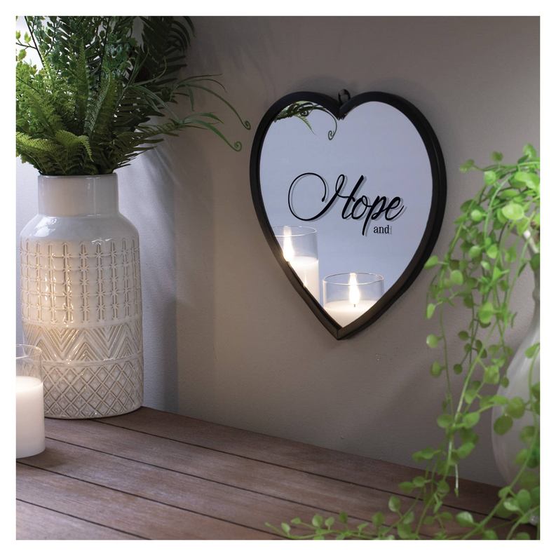 Heart-shaped wall mirror with black frame, lit candle view, and “Hope and” design