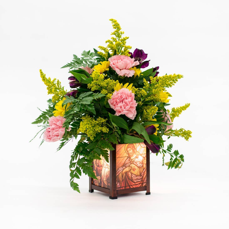 Decorative glass lantern warmer holding floral bouquet, brown frame