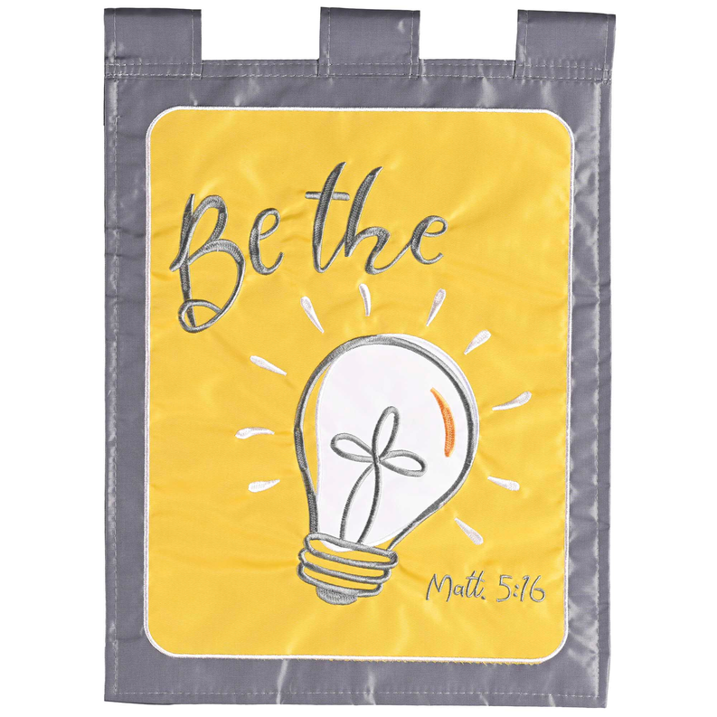 Yellow fabric hanging flag with light bulb graphic and "Be the Light" text