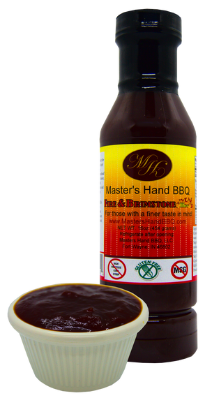 BBQ sauce bottle with small cup of dark red sauce and yellow label