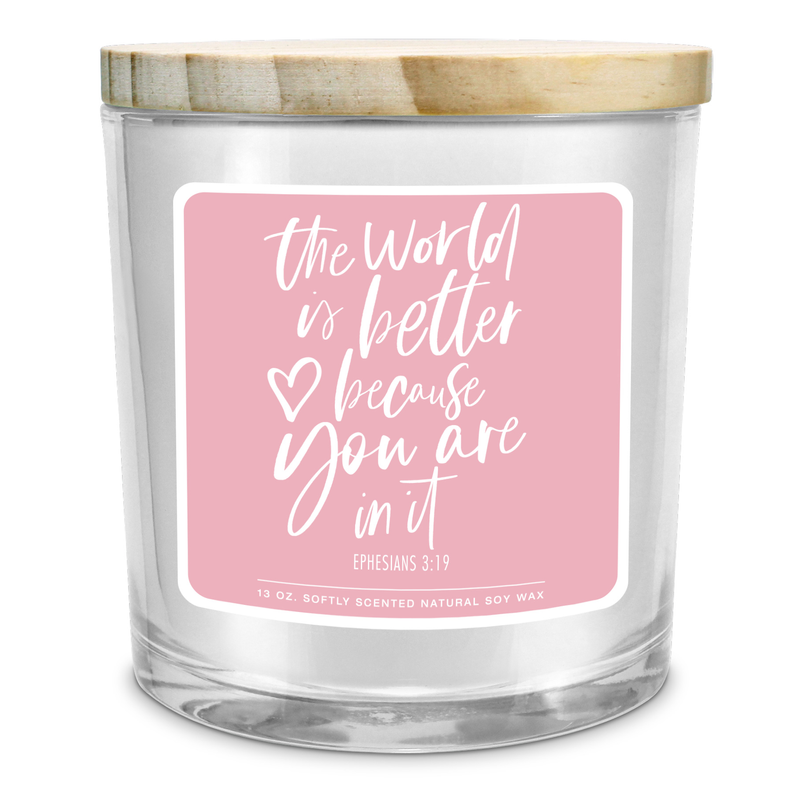 Soy candle jar with pink label text "the World is Better" in white script