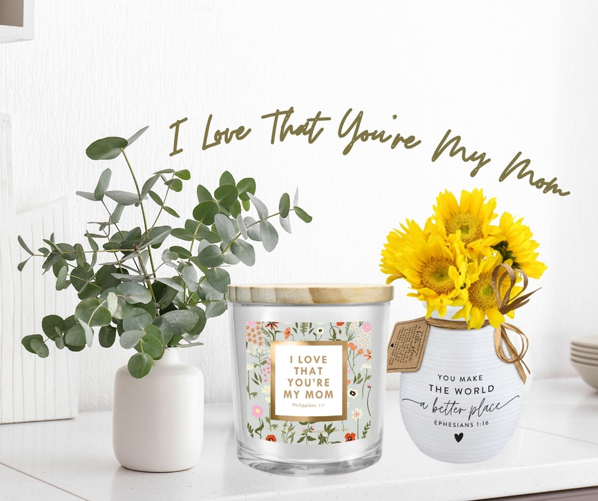 Soy candle in clear glass jar with gold wax lid and floral Mom message label