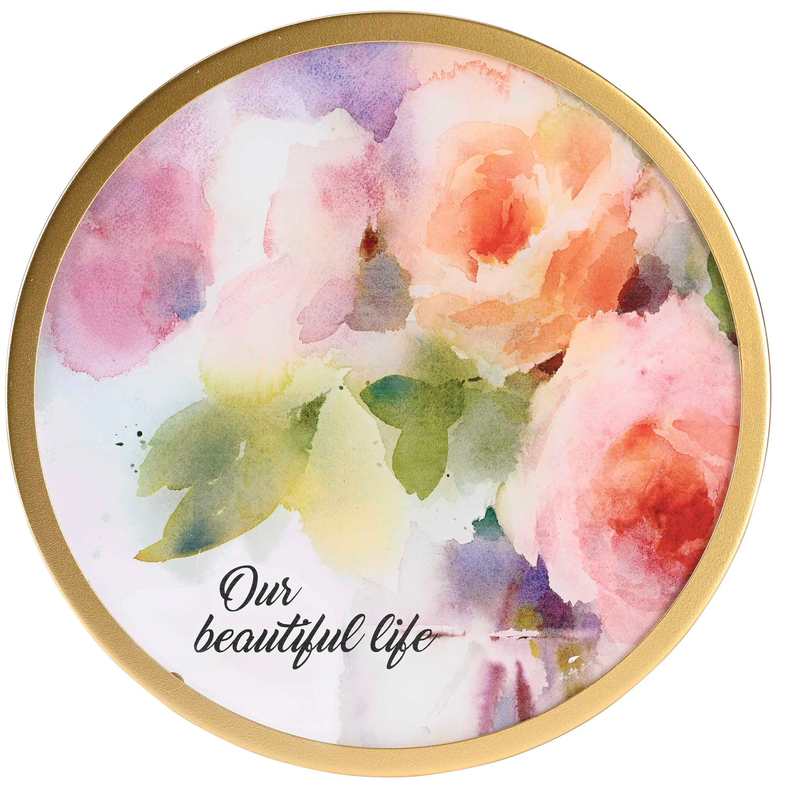 Circular framed wall art with gold border, watercolor florals and cursive "Our beautiful life".