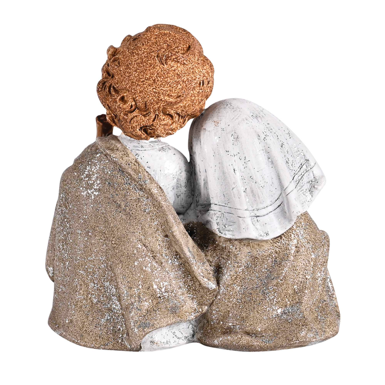 Distressed nativity figurine of Mary and Joseph holding baby, blue-gray and tan robes