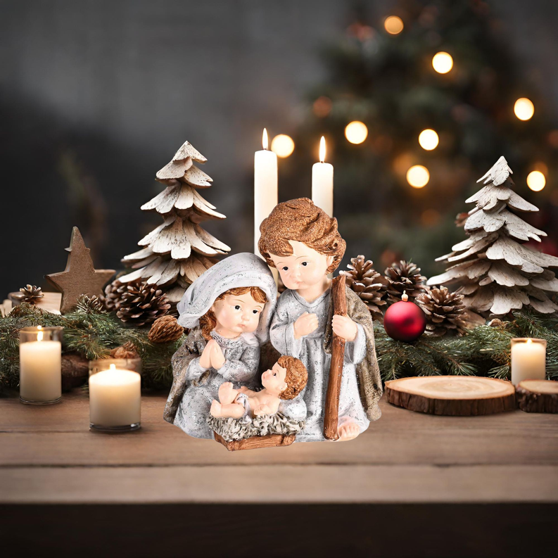 Candlelit nativity holy family figurines: Mary and Joseph holding baby, blue-gray robes