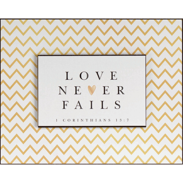 Framed quote print: LOVE NEVER FAILS with heart and 1 Corinthians 13:7.