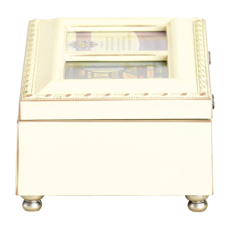 Ivory music box with decorative trim and open top window showing booklet panels