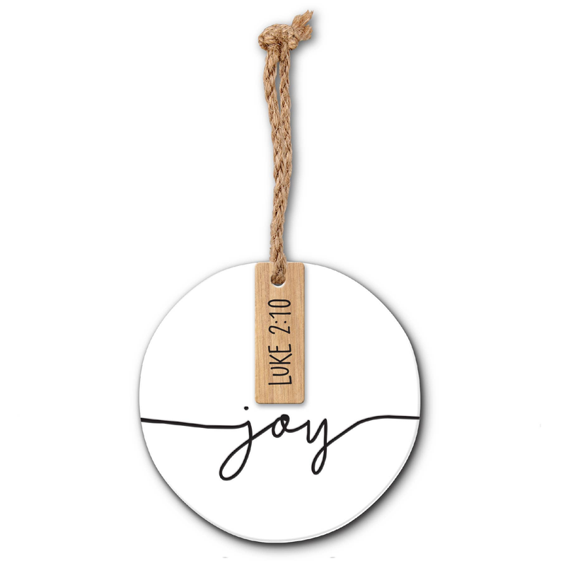 White round Christmas ornament with twine and wood tag, 'joy' script.